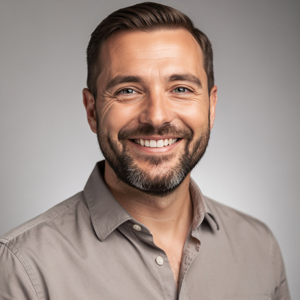 Studio portrait of a smiling man with short beard